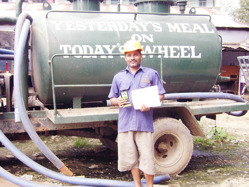 Rajkumar stands tall in uniform with his certificate and medal of honour.